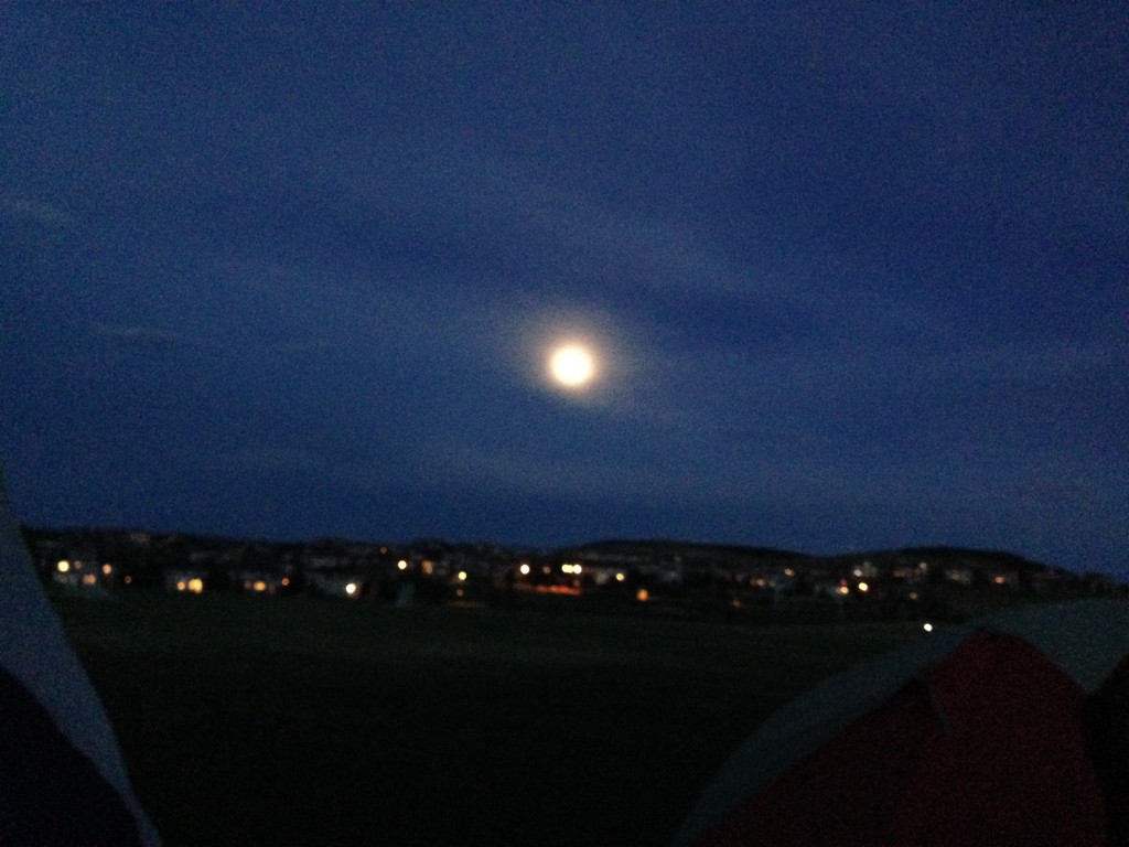 Moon over the city lights