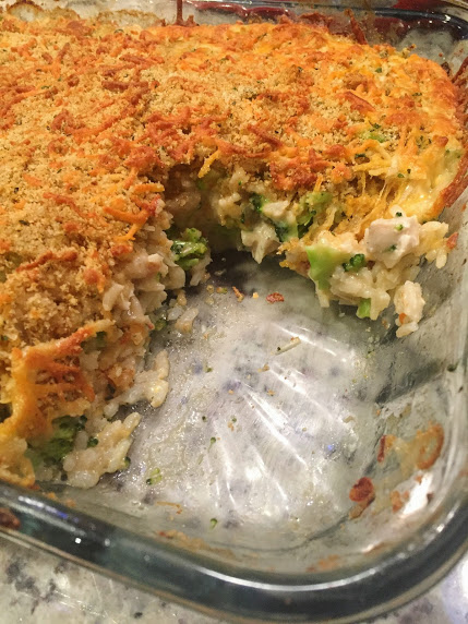 casserole dish with one slice missing in a chicken broccoli rice meal