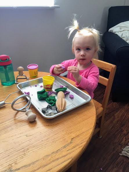 Toddler Activity: Zoey and Play-Doh on a tray with random kitchen utensils