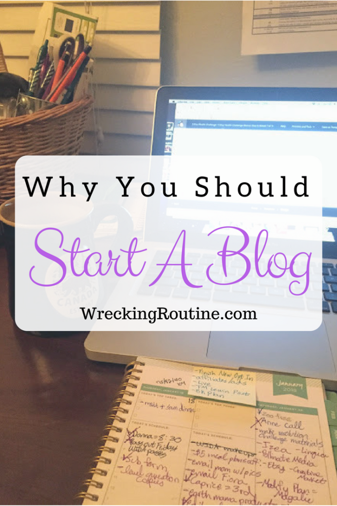 Desk with computer, planner, and tea in the early morning