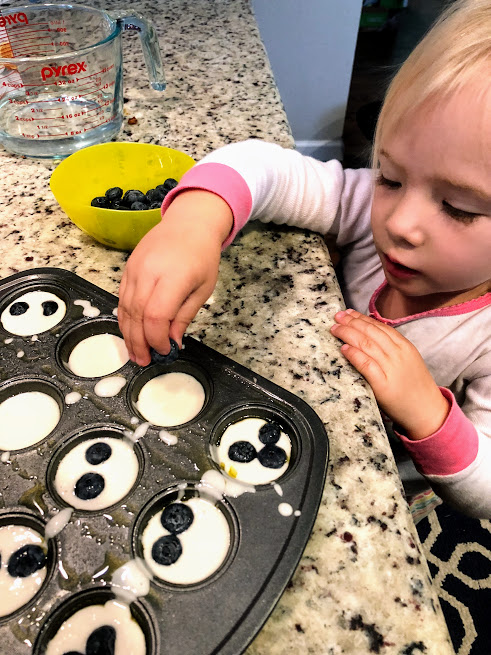 Zoey making pancake muffins