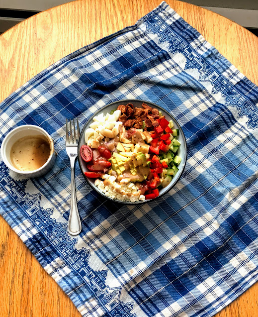 Cobb Salad in a bowl on top of a placemat