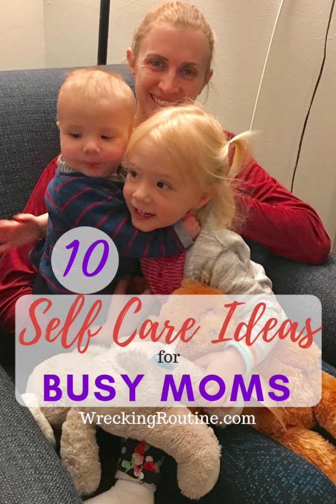 Mother and two children on her lap smiling. Text says 10 Self Care Ideas for Busy Moms