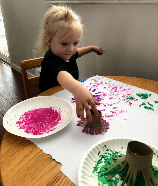 Girl making fireworks with paint for  29 beginner craft projects for young kids