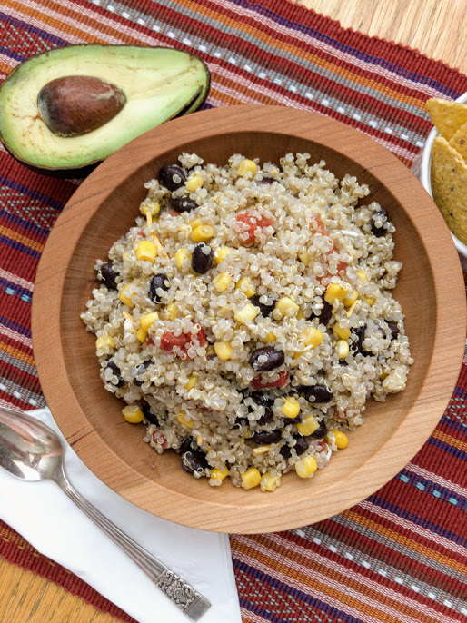 bowl with quinoa dinner dip, spoon, and half an avocado