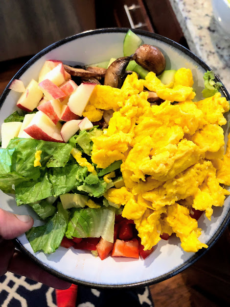 bowl of salad with spinach, apple, egg for healthy meals for runners