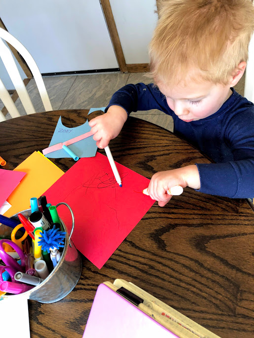 Boy using a marker for  29 beginner craft projects for young kids