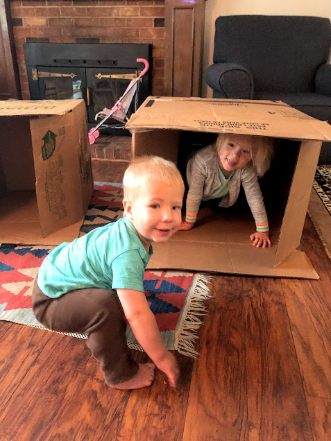Two kids in large cardboard box for no screen activities for kids