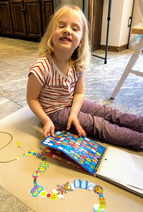 Girl making sticker line for  29 beginner craft projects for young kids