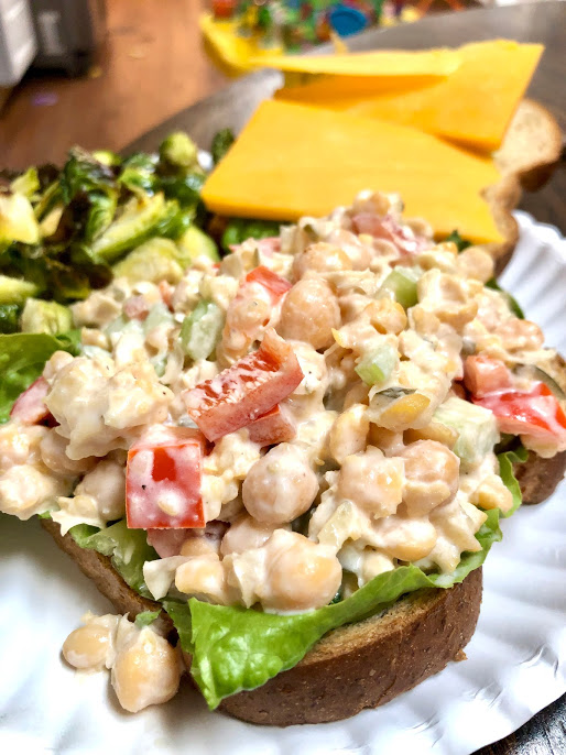 chickpea mash recipe on top of a bread with broccoli on side