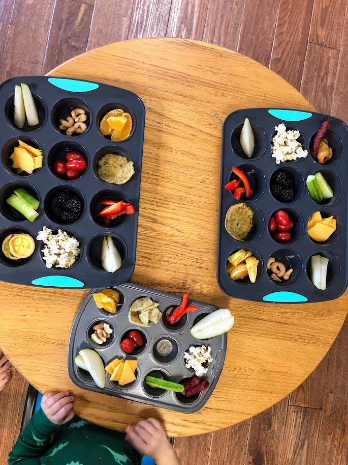 Three separate pans of muffin pan meals