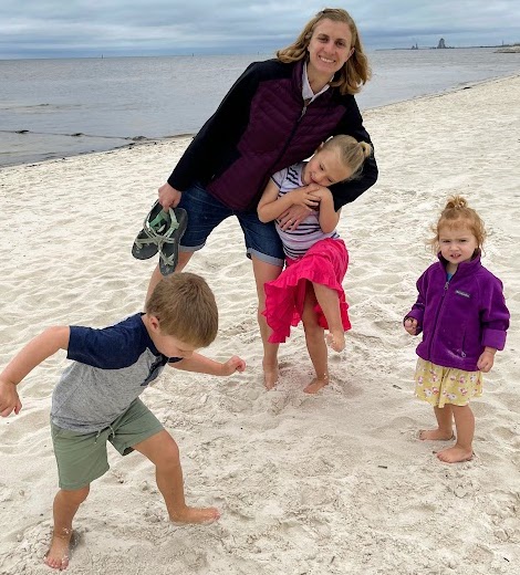 Stay at home mom on the beach with her kids