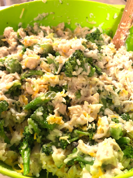 chicken broccoli rice casserole in a green mixing bowl for new moms freezer meals