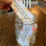 family conversation starters in a mason jar with one being pulled out