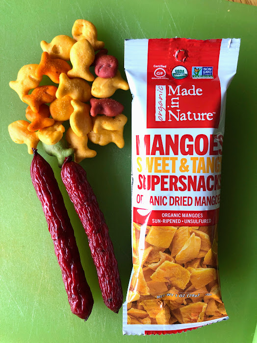 goldfish, dried mango pack, and jerky for road trip snacks