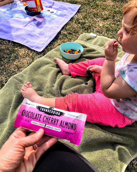 Thunderbird chocolate cherry almond bar outside with baby feet on a towel