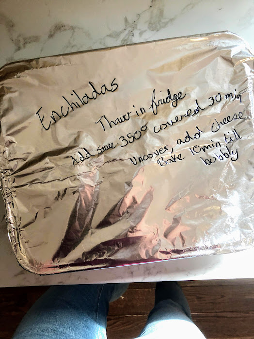 Freezer pan of enchiladas with sharpie label for new mom freezer meals