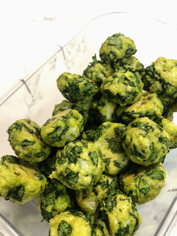 iron packed spinach balls in a food storage container